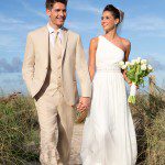 Bride and groom walking on beach path
