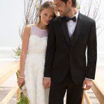 Bride and groom holding hands on beach