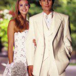 Smiling bride and groom in white wedding attire
