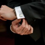 Close-up of person adjusting suit cufflink