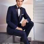 Man wearing navy tuxedo, formal seated pose