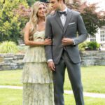 Couple in formal attire posing in garden