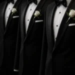 Three groomsmen wearing black tuxedos with boutonnieres